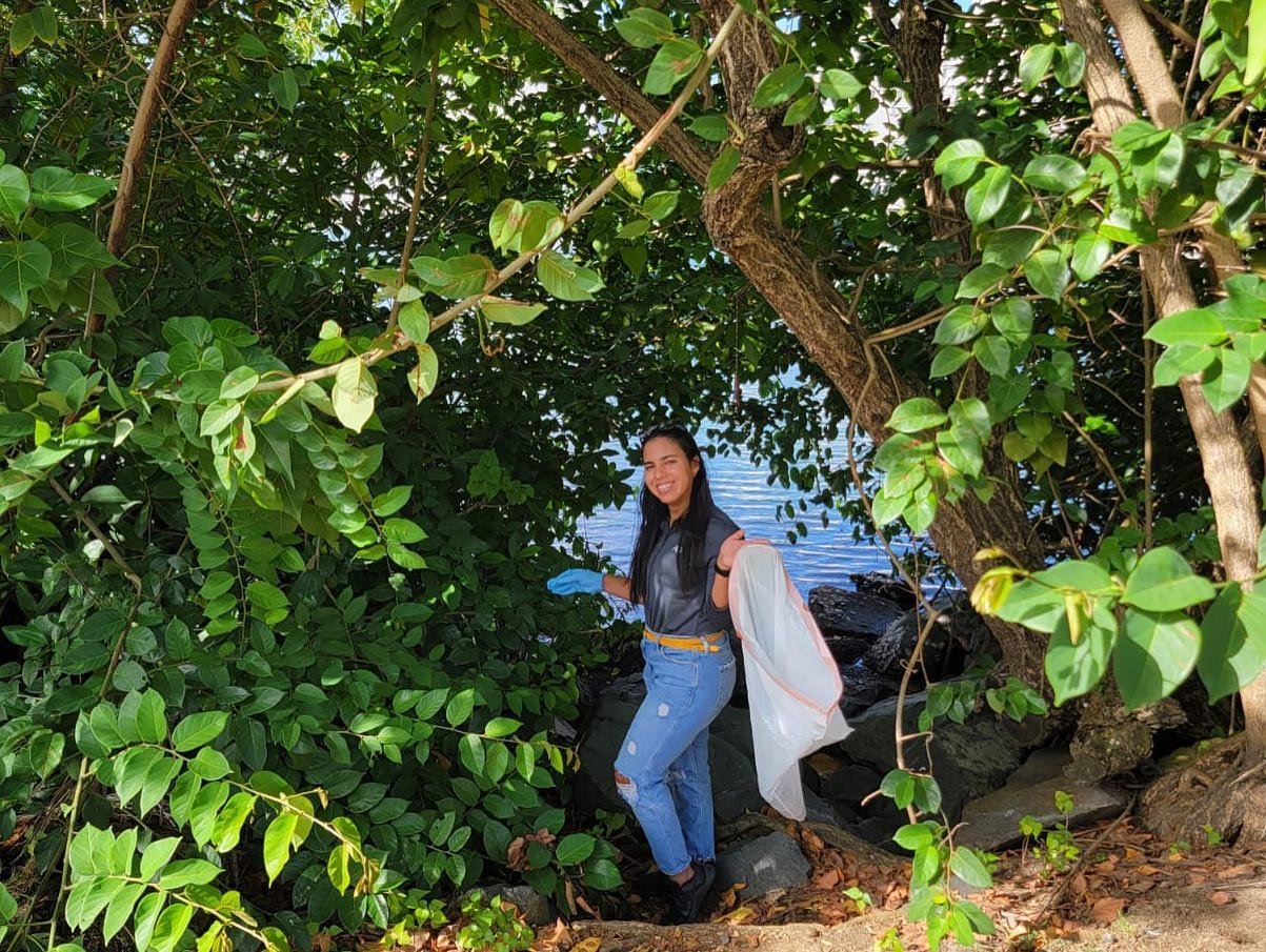  AD&amp;V team member participating in Condado Lagoon cleanup team building activity 