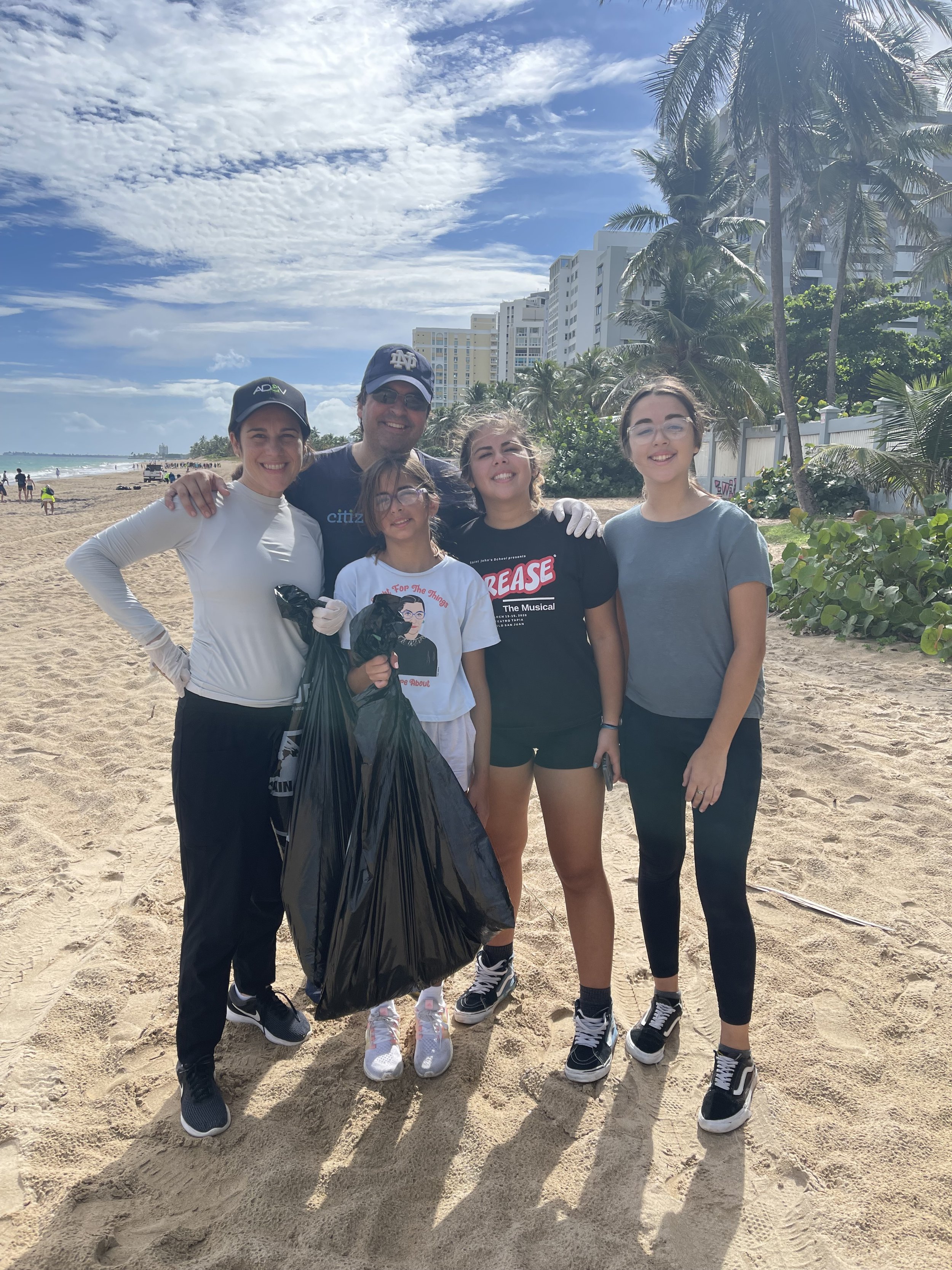  AD&amp;V team members picking up trash at a local beach. 