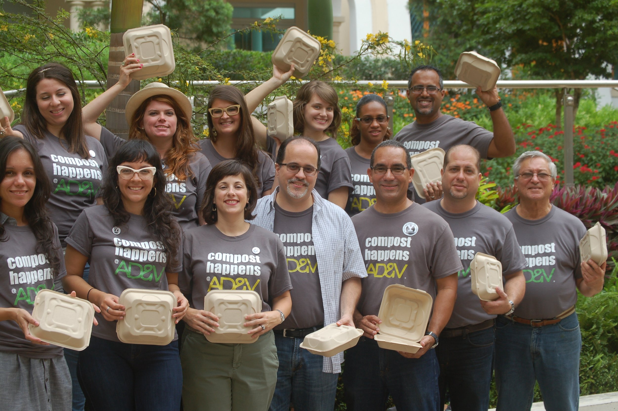  AD&amp;V team posing for picture with compostable food container 