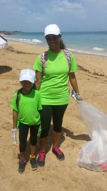  AD&amp;V team member and family posing for picture at beach cleanup 