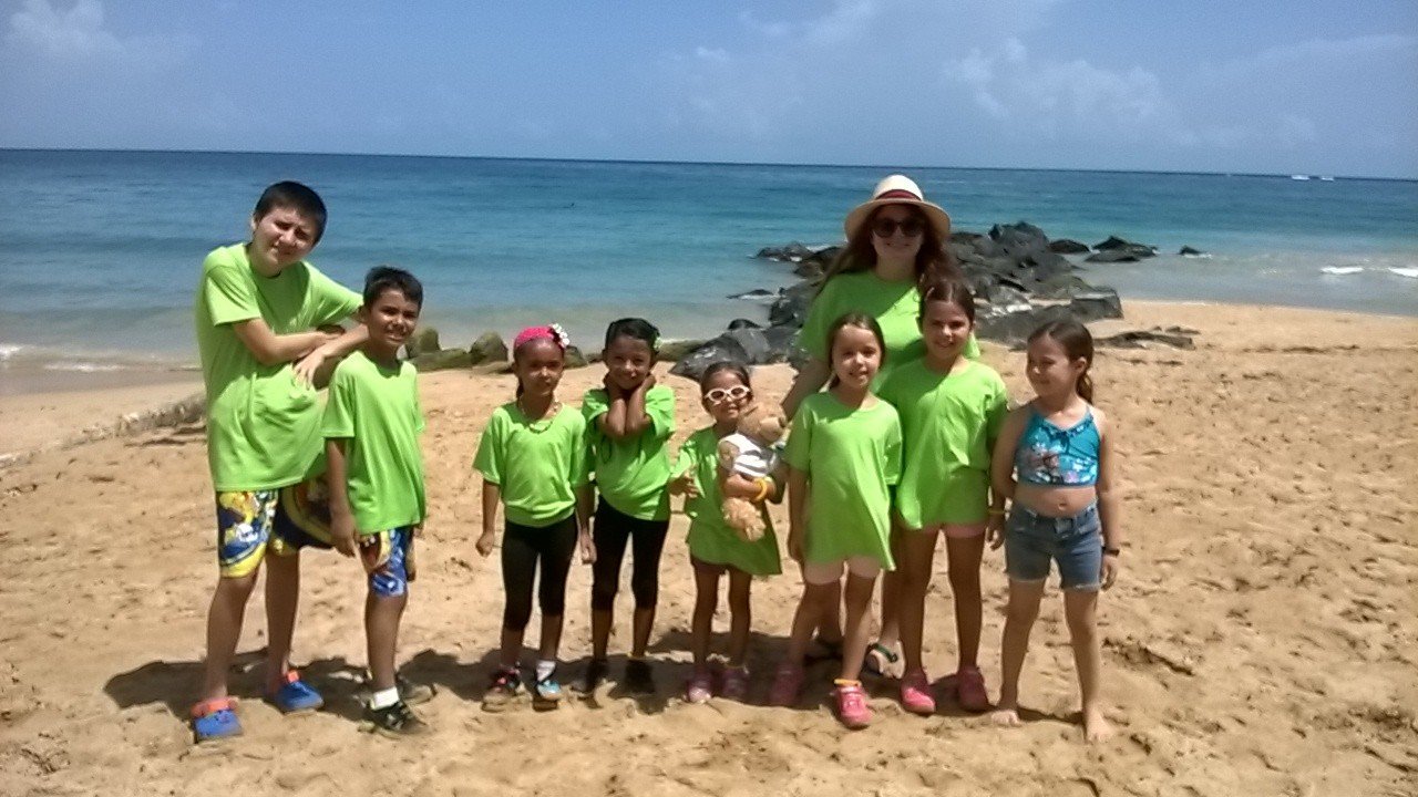  AD&amp;V team members and family posing for picture at beach clean up 